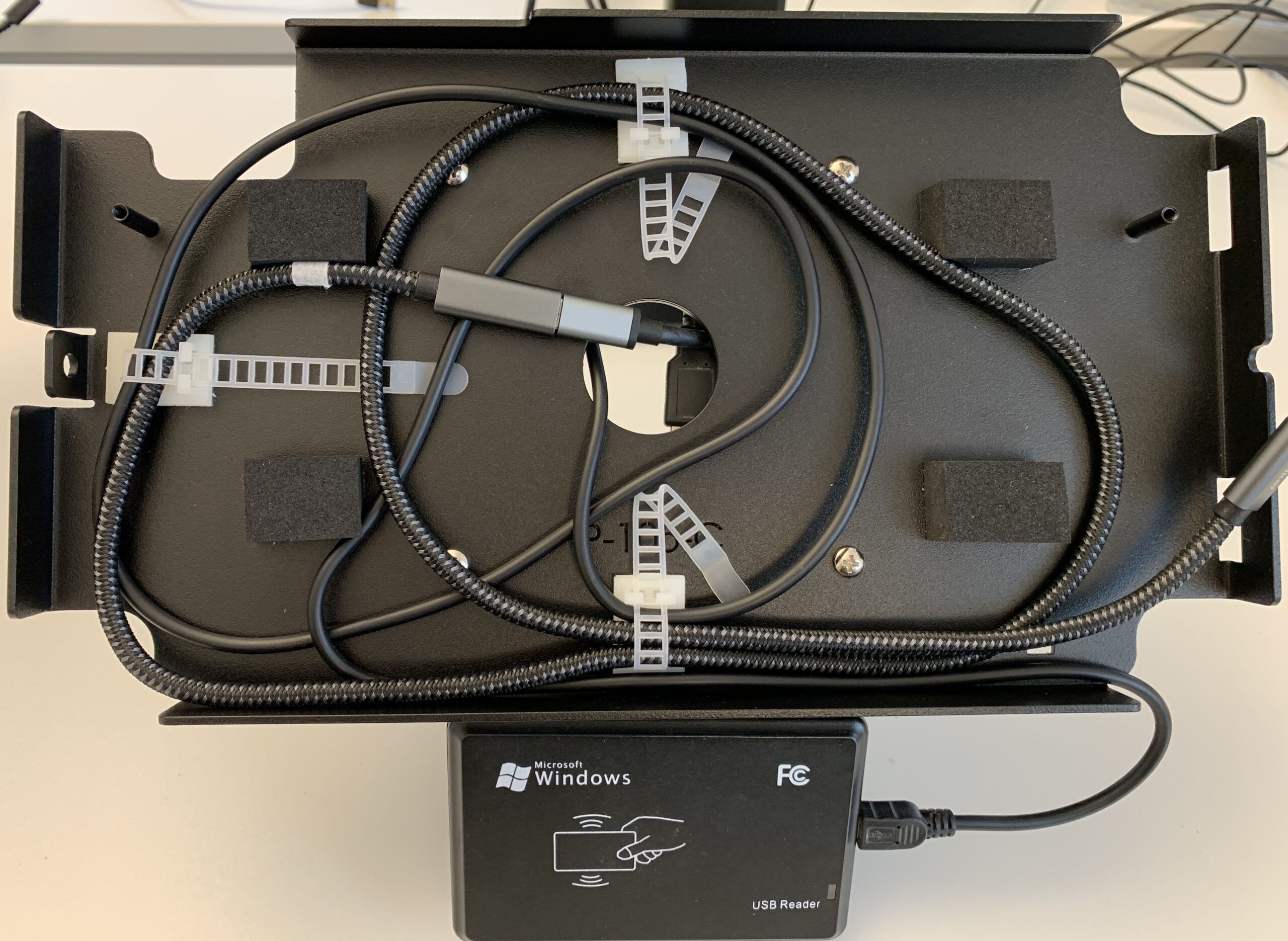 The tablet is connected with the USB-C plug and placed in the holder