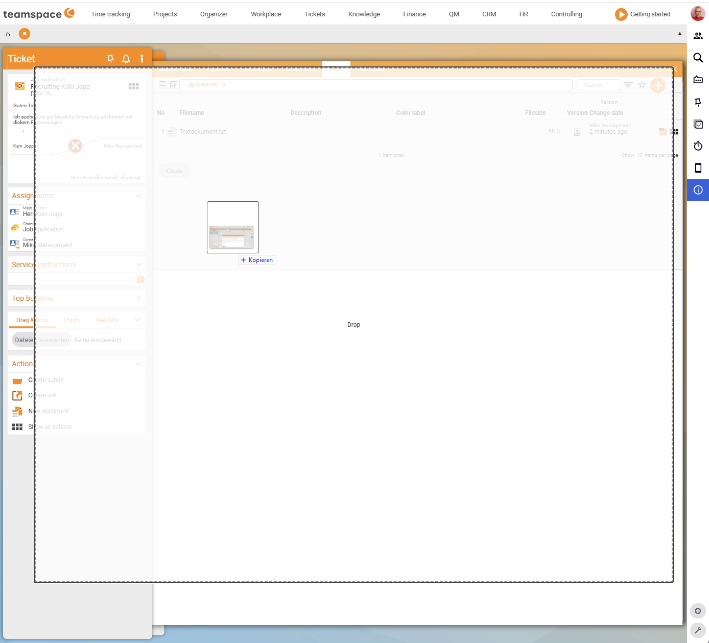 A file being dragged into the directory via drag & drop; the drop area is marked with a dashed border and reads Drop
